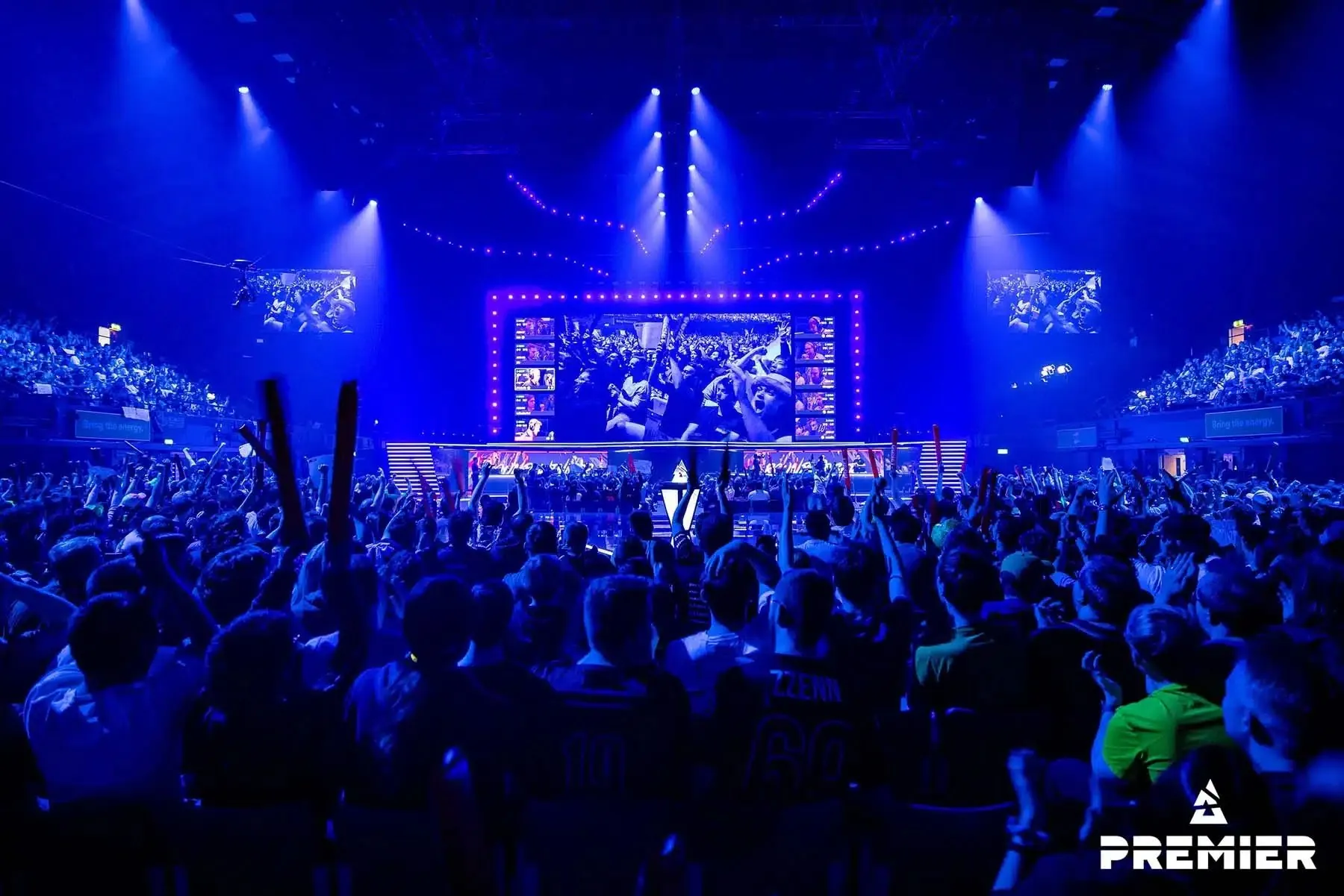 A BLAST Premier arena under blue light with a full crowd